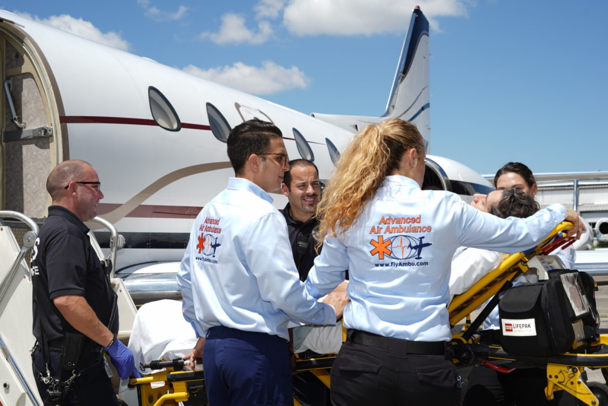 Advanced Air Ambulance medics load a patient onto the air ambulance plane.